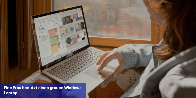 Eine Frau benutzt einen grauen Windows-Laptop